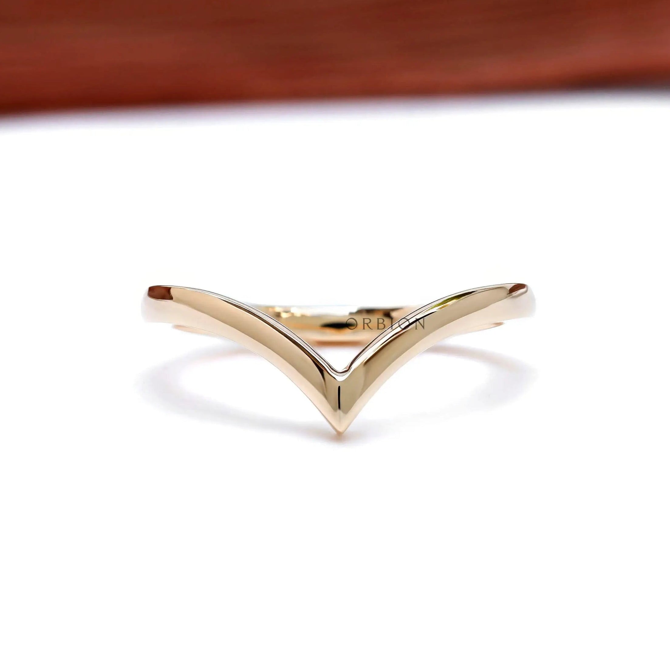 Front view of 14K yellow gold wishbone chevron stacking band.