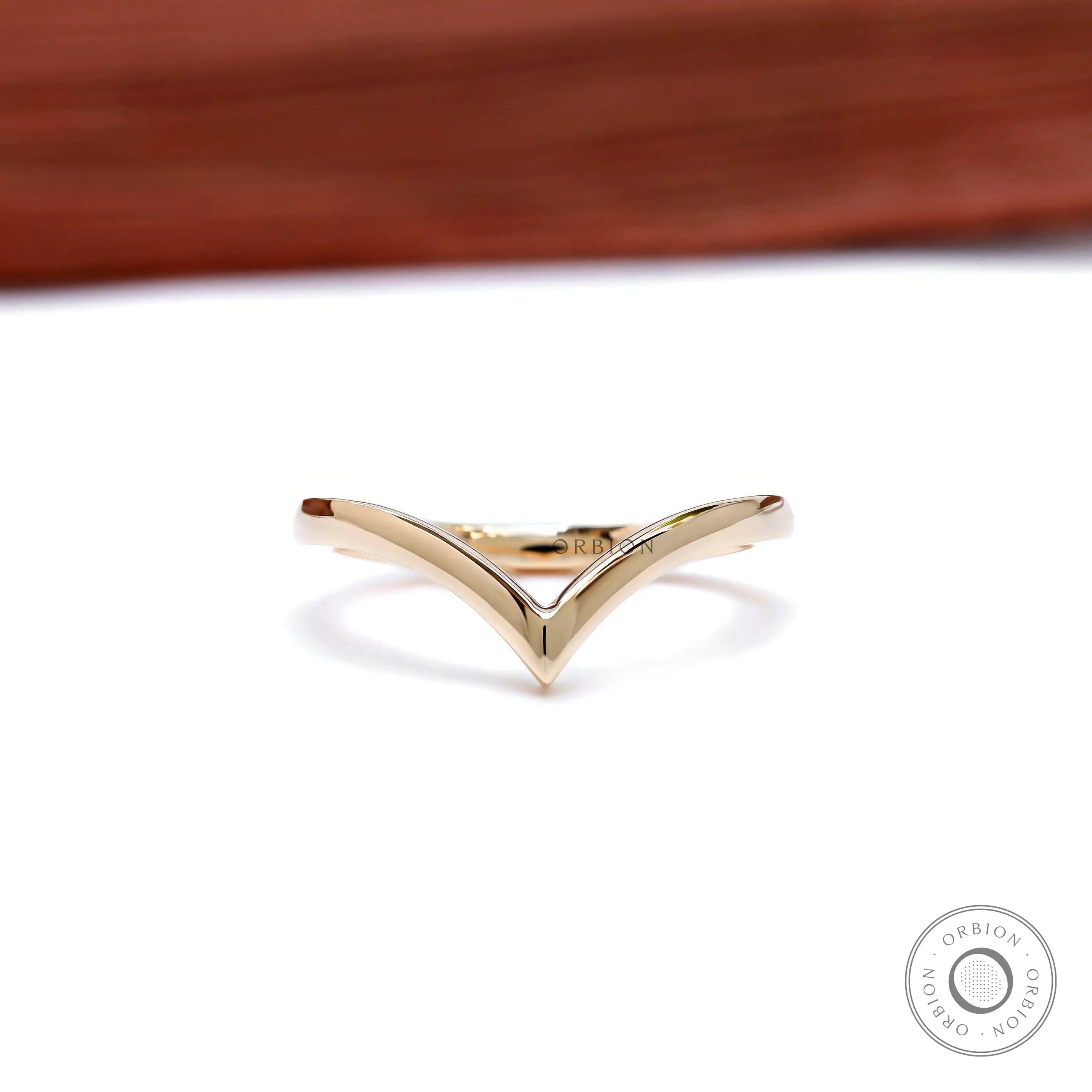 Front view of 14K yellow gold wishbone chevron stacking band.