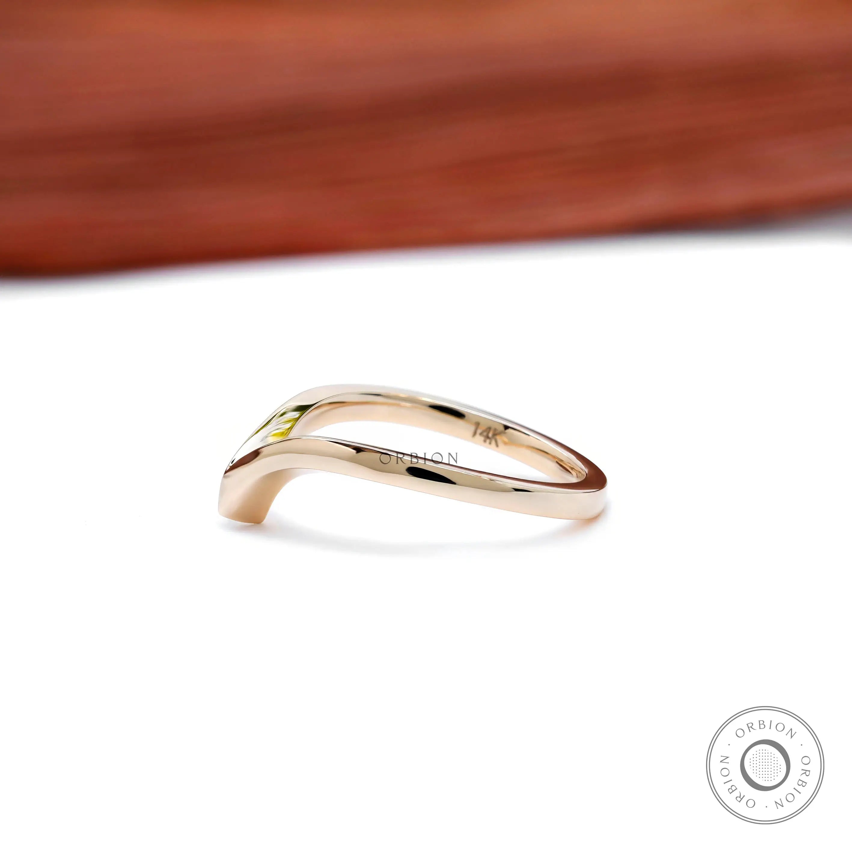 Side angle showing polished V-shaped chevron wedding band.