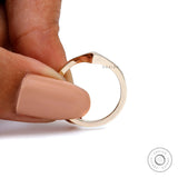 Close-up held view showing pointed V tip and mirror finish.