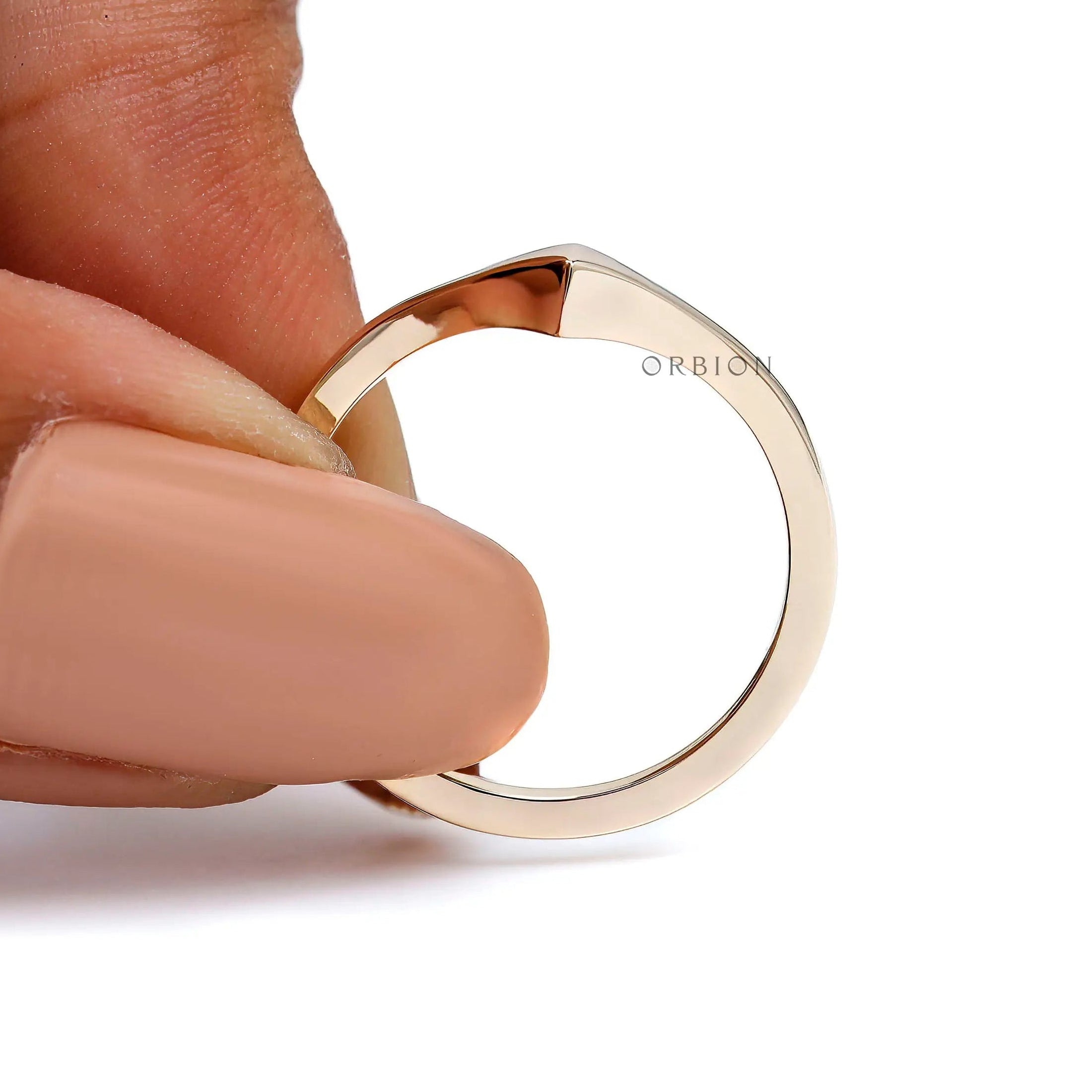 Close-up held view showing pointed V tip and mirror finish.