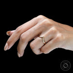 On-hand front view of minimalist wishbone chevron ring.