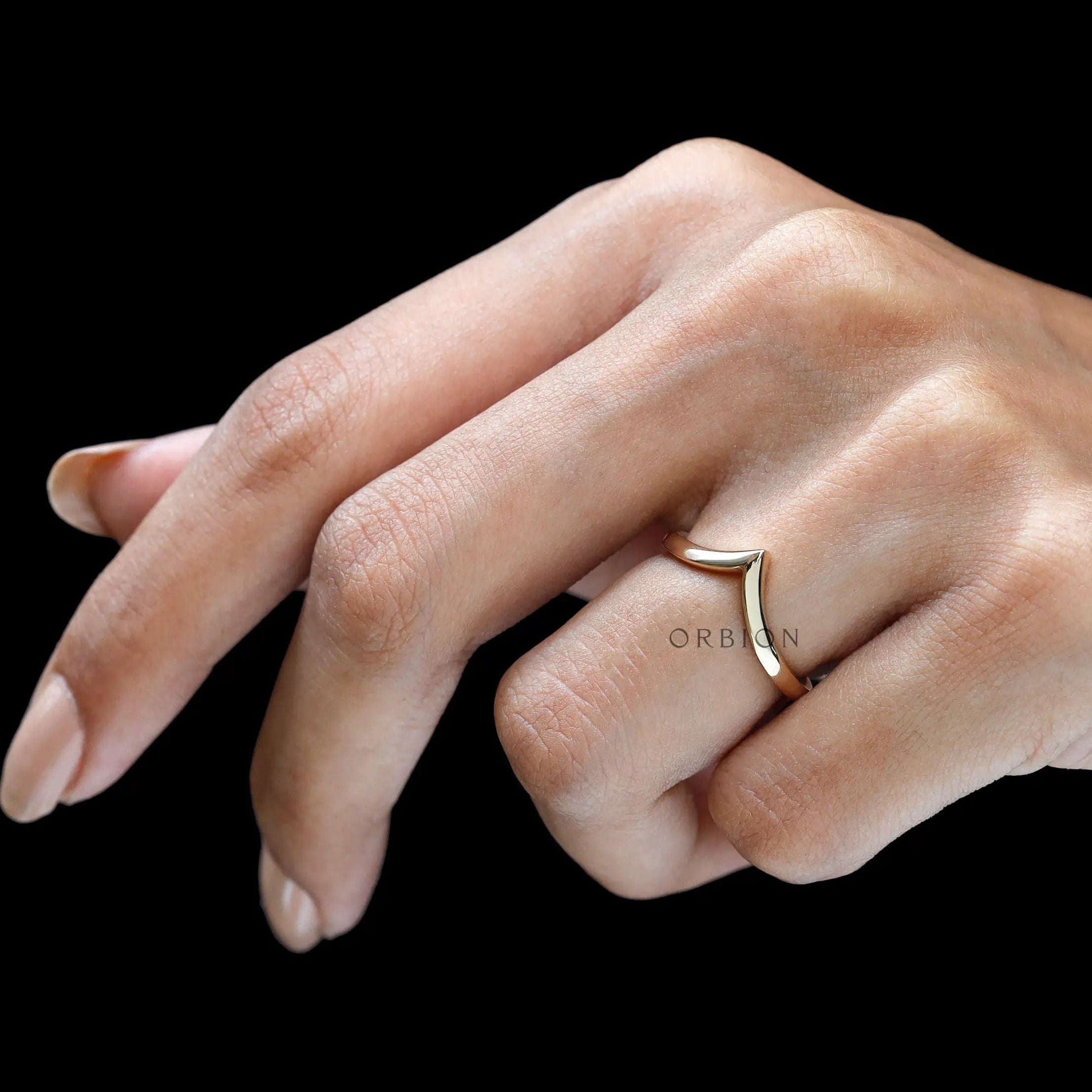 On-hand front view of minimalist wishbone chevron ring.