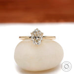Oval moissanite solitaire ring in yellow gold, front view.