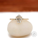 Oval moissanite solitaire ring in yellow gold, front view.