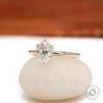 Angled view of oval moissanite six prong tulip setting solitaire ring.