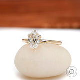 Angled view of oval moissanite six prong tulip setting solitaire ring.