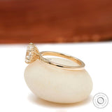 Side profile showing dainty tulip basket and slim yellow gold band.
