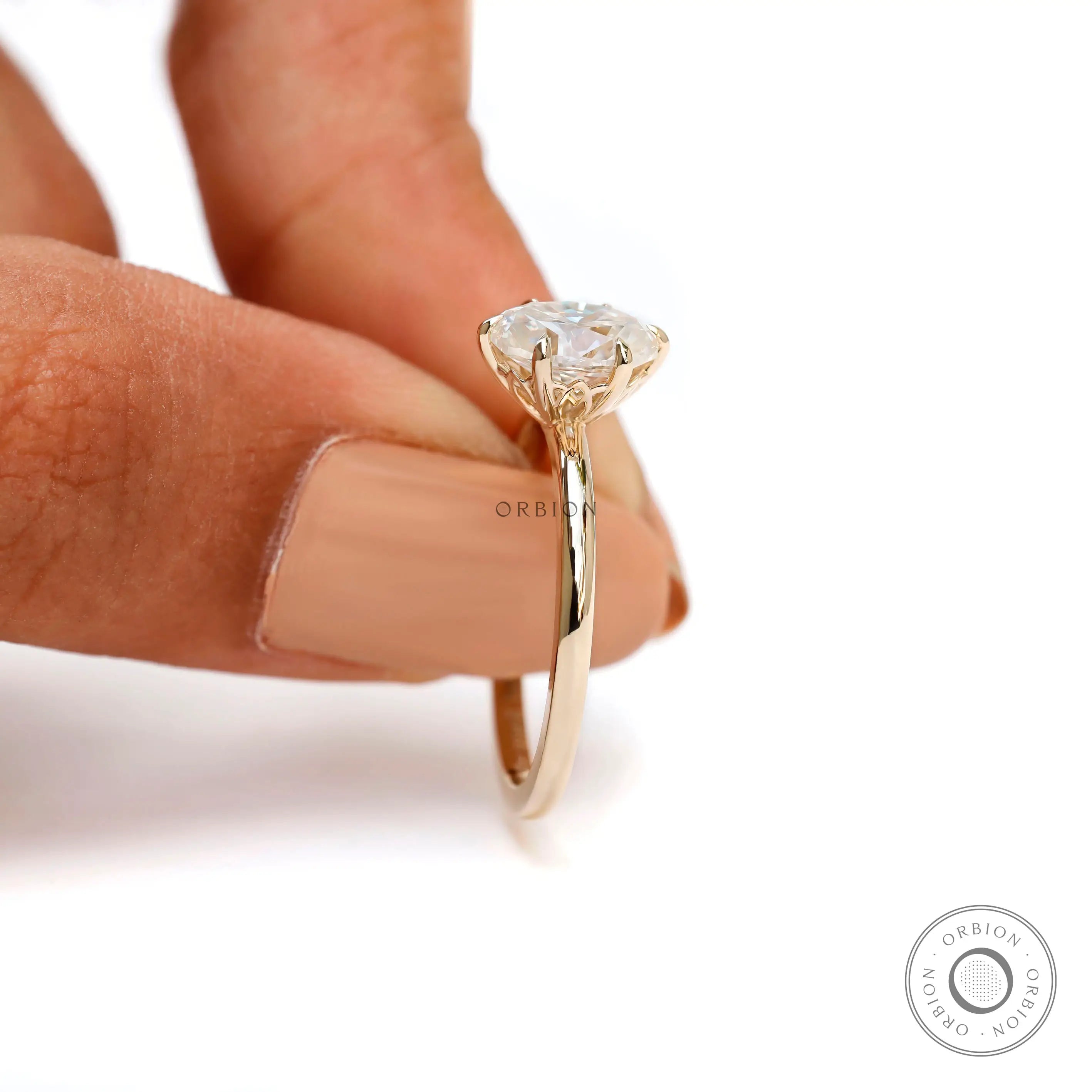 Close side view of oval moissanite prongs and tulip basket detail.