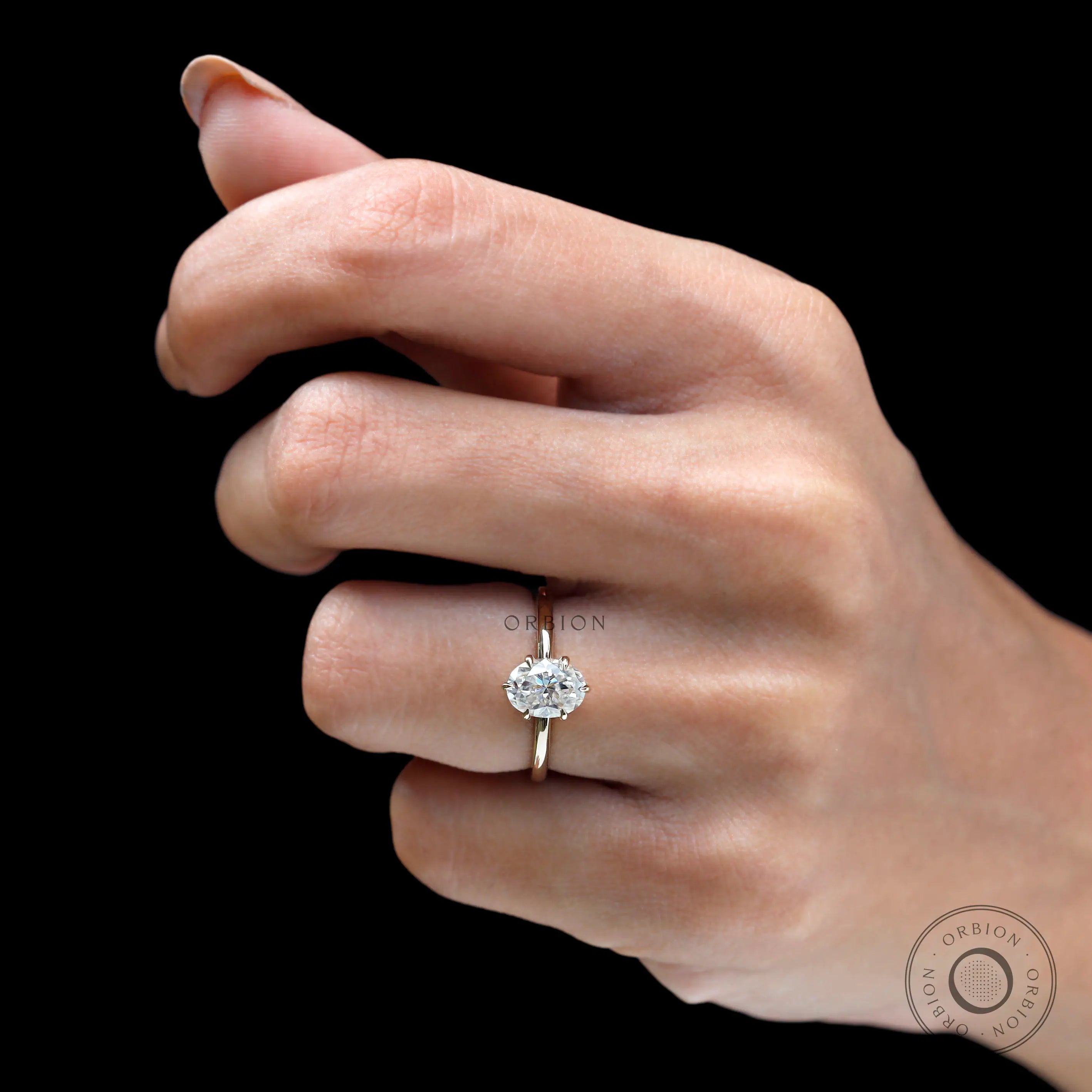 On-hand side profile showing low, delicate tulip setting in yellow gold.