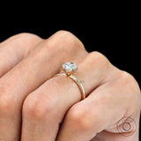On-hand top view of oval moissanite solitaire, minimal dainty band.