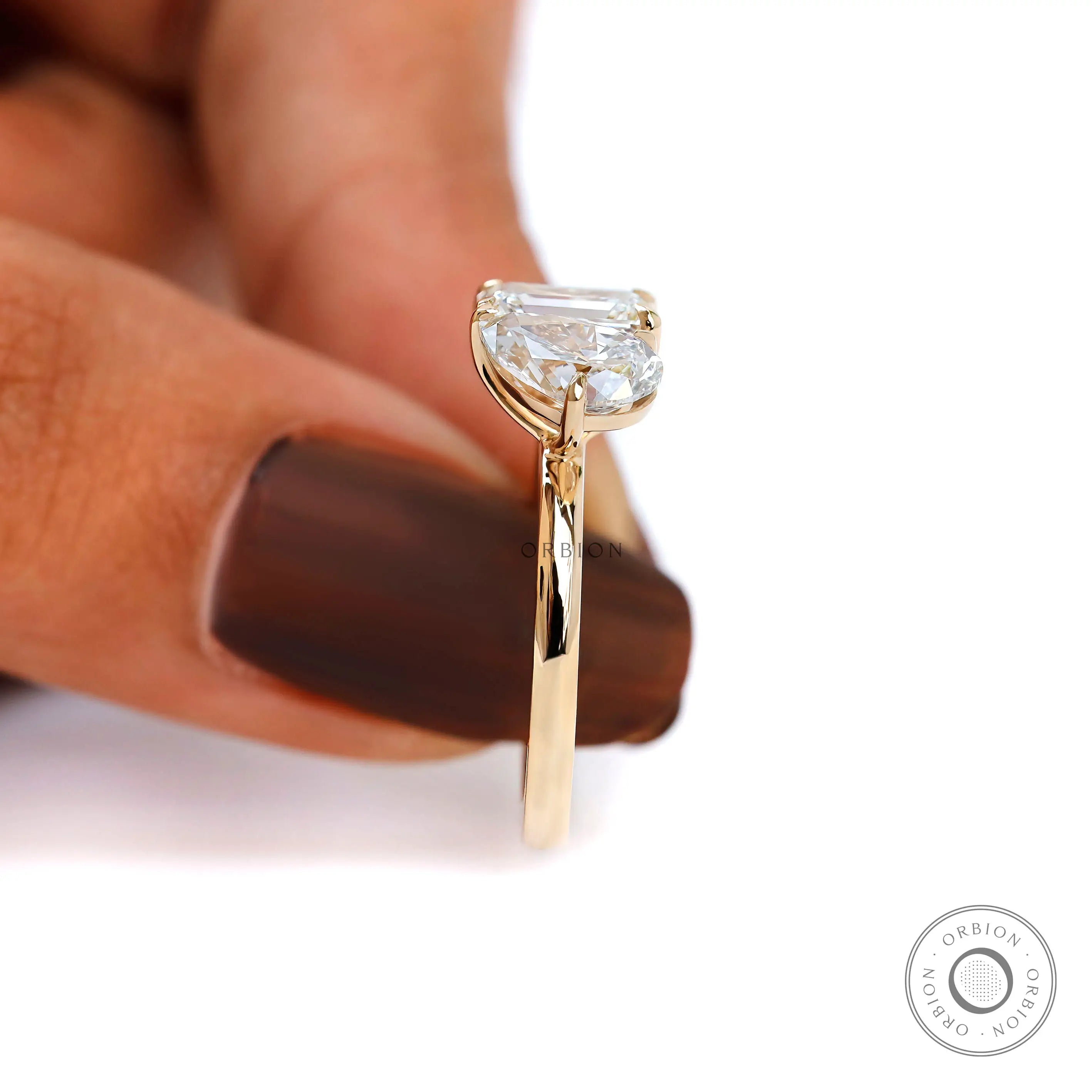 Side view on fingers showing comfortable height and refined profile.