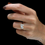 Hand model view showcasing modern two stone engagement ring sparkle.