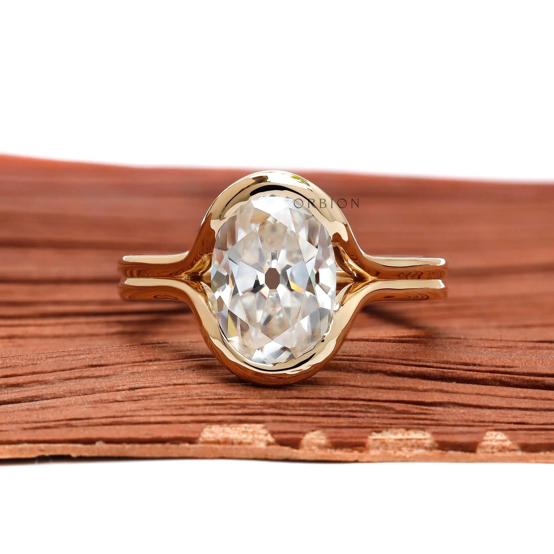 Front view oval moissanite in half bezel split shank ring