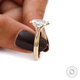 Profile closeup of half bezel oval moissanite split shank