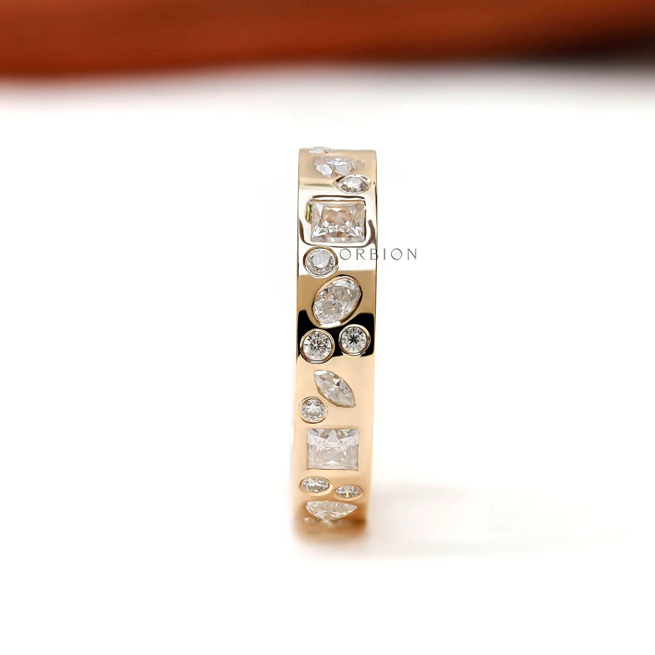 Full eternity band upright showing scattered mix-shape stone pattern.