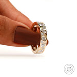 Handheld close-up highlighting baguette, pear, and round stone details.