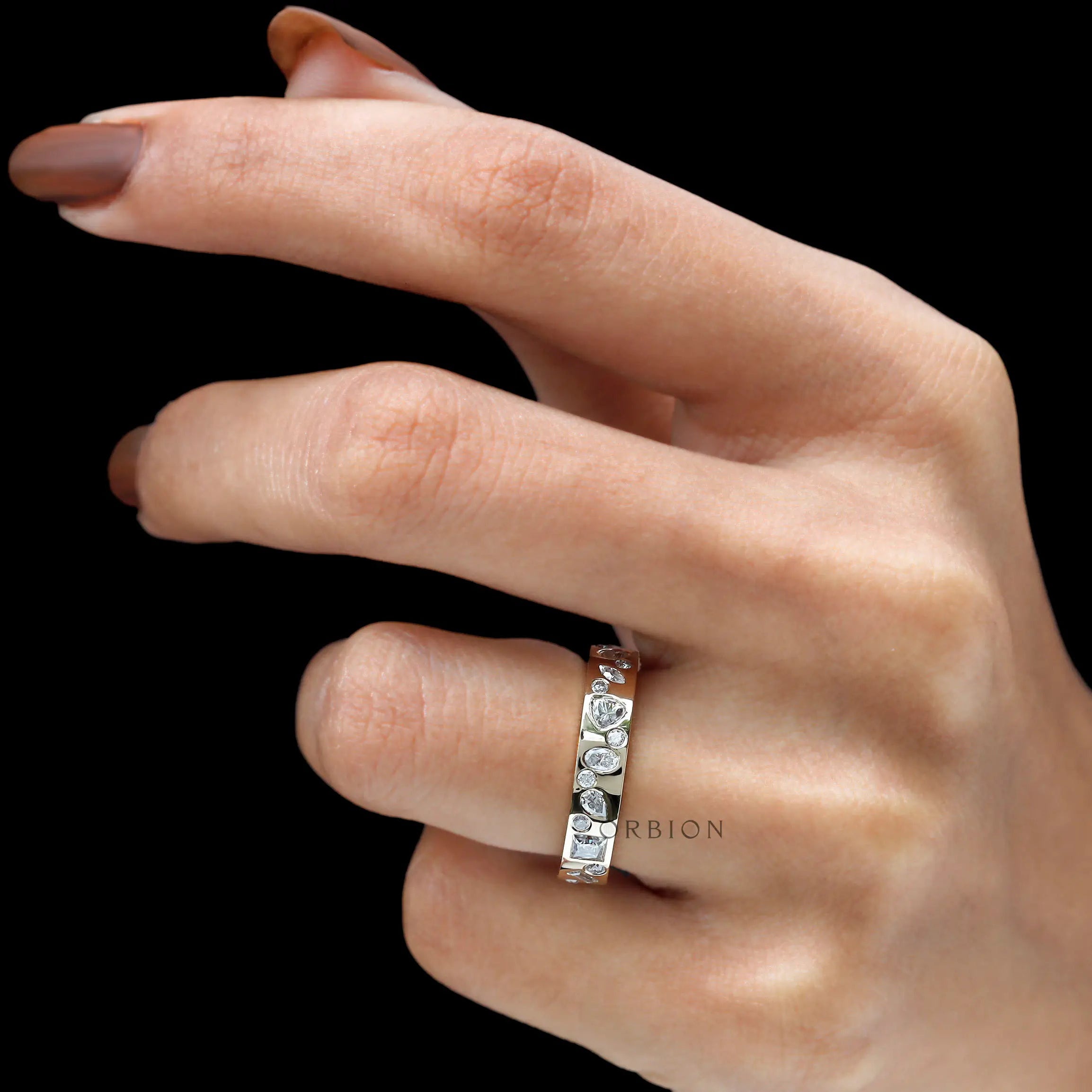 Mix-shape eternity wedding band worn on hand, lifestyle view.