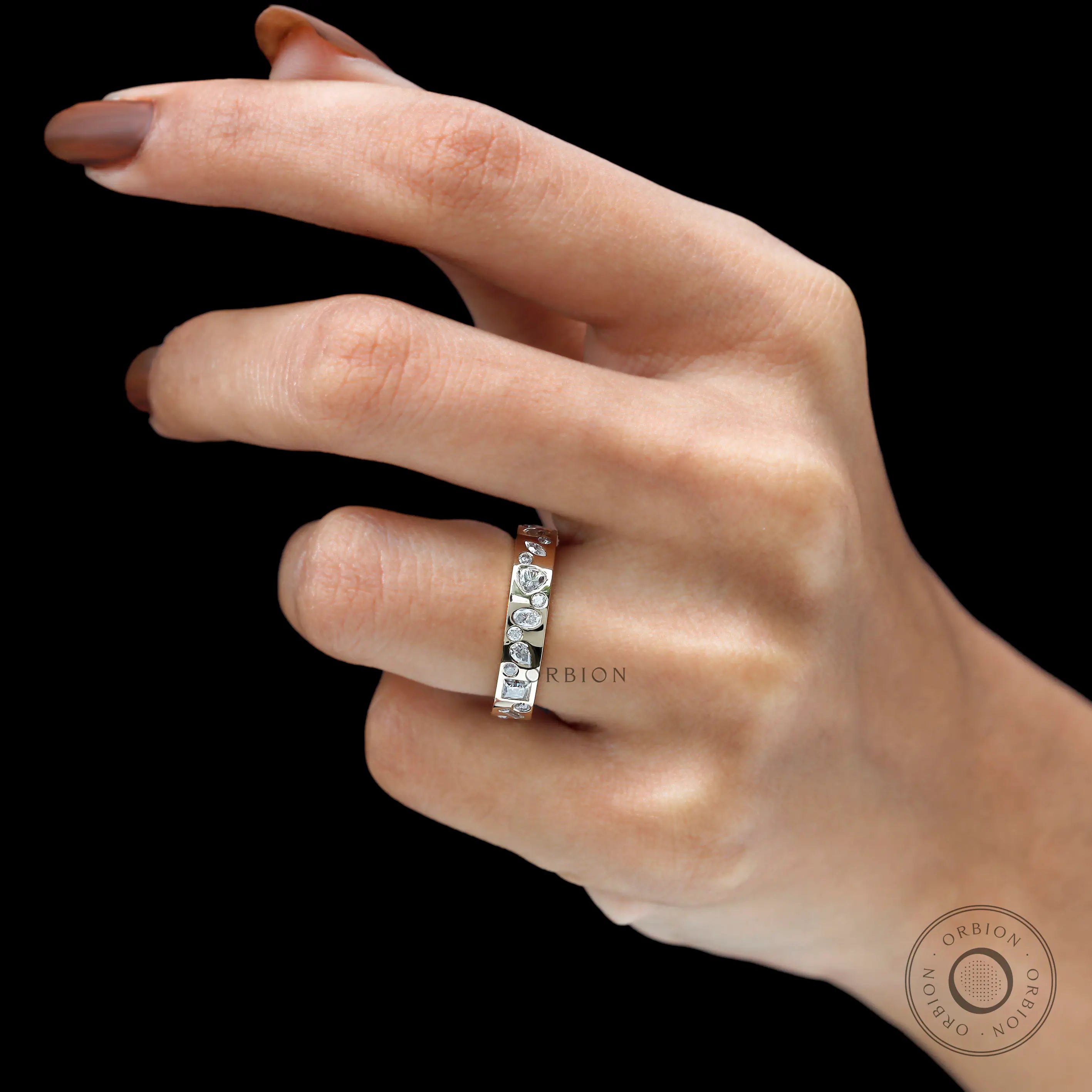 Mix-shape eternity wedding band worn on hand, lifestyle view.