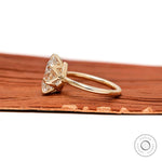 Side profile showing crown prong setting and yellow gold band