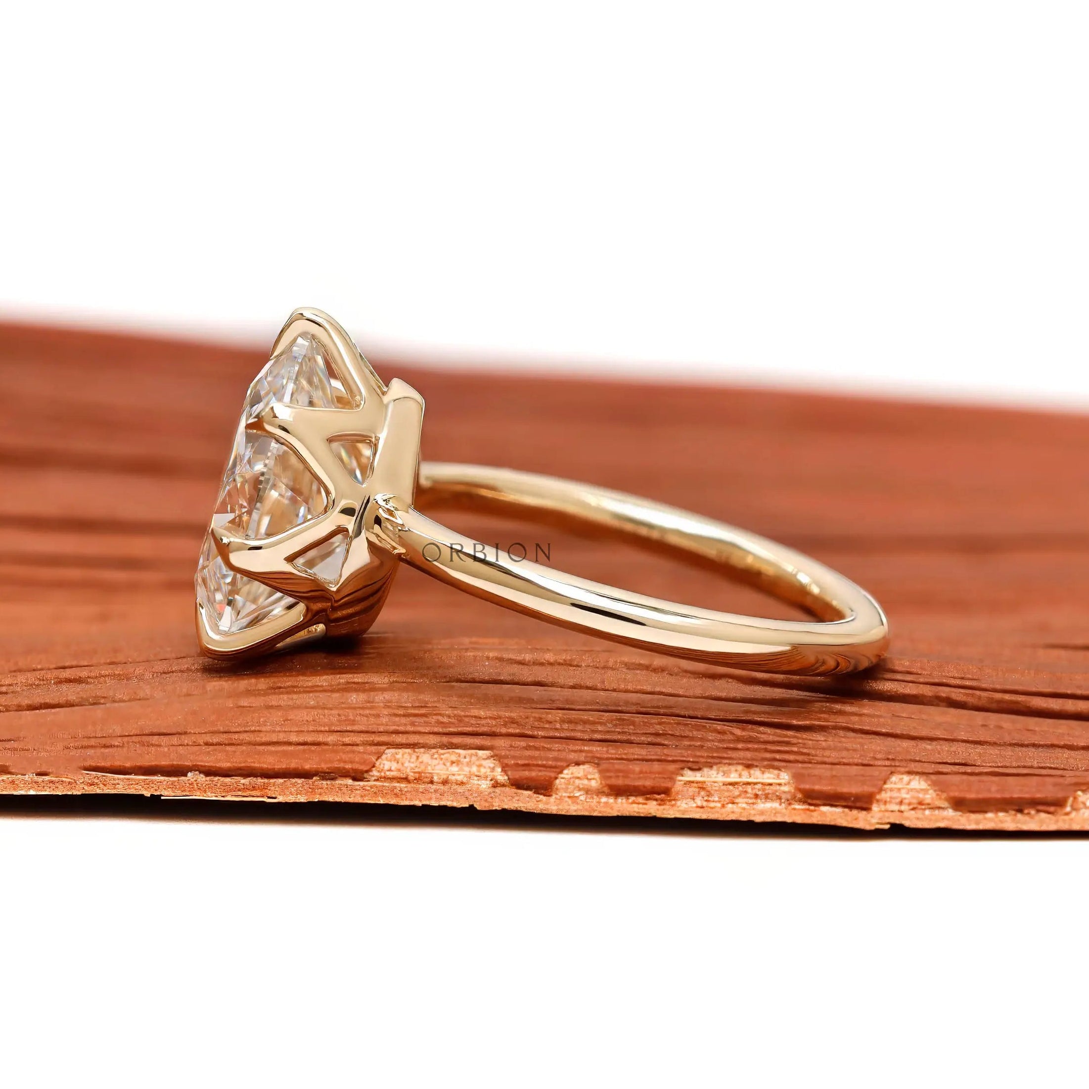 Side profile showing crown prong setting and yellow gold band