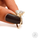 Detailed prong craftsmanship supporting custom cut pear diamond