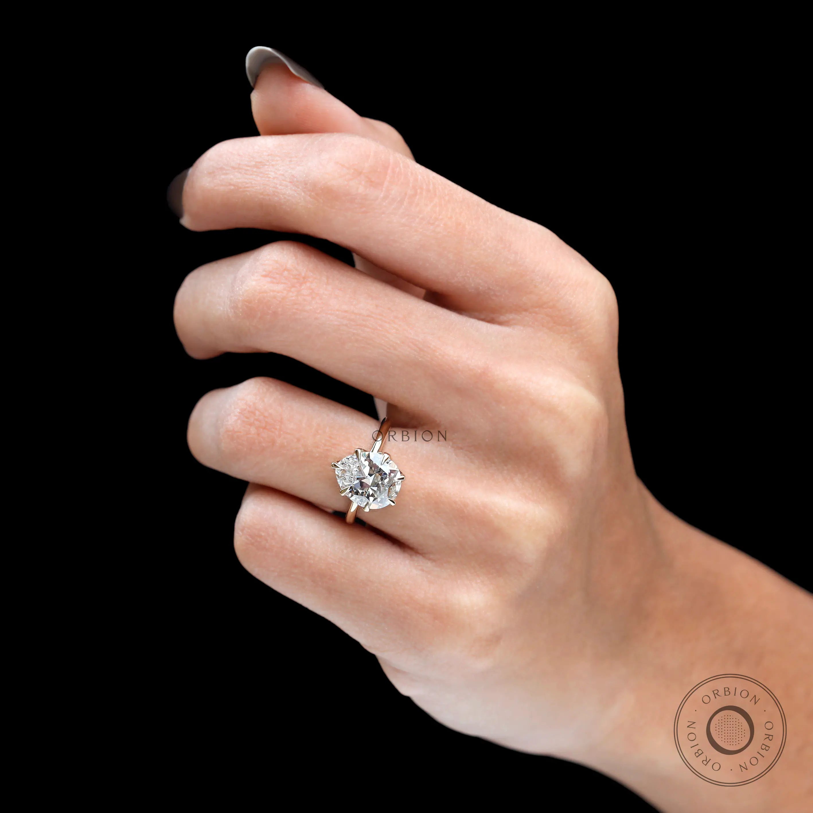 On-finger view showing fat pear diamond scale and elegant proportions