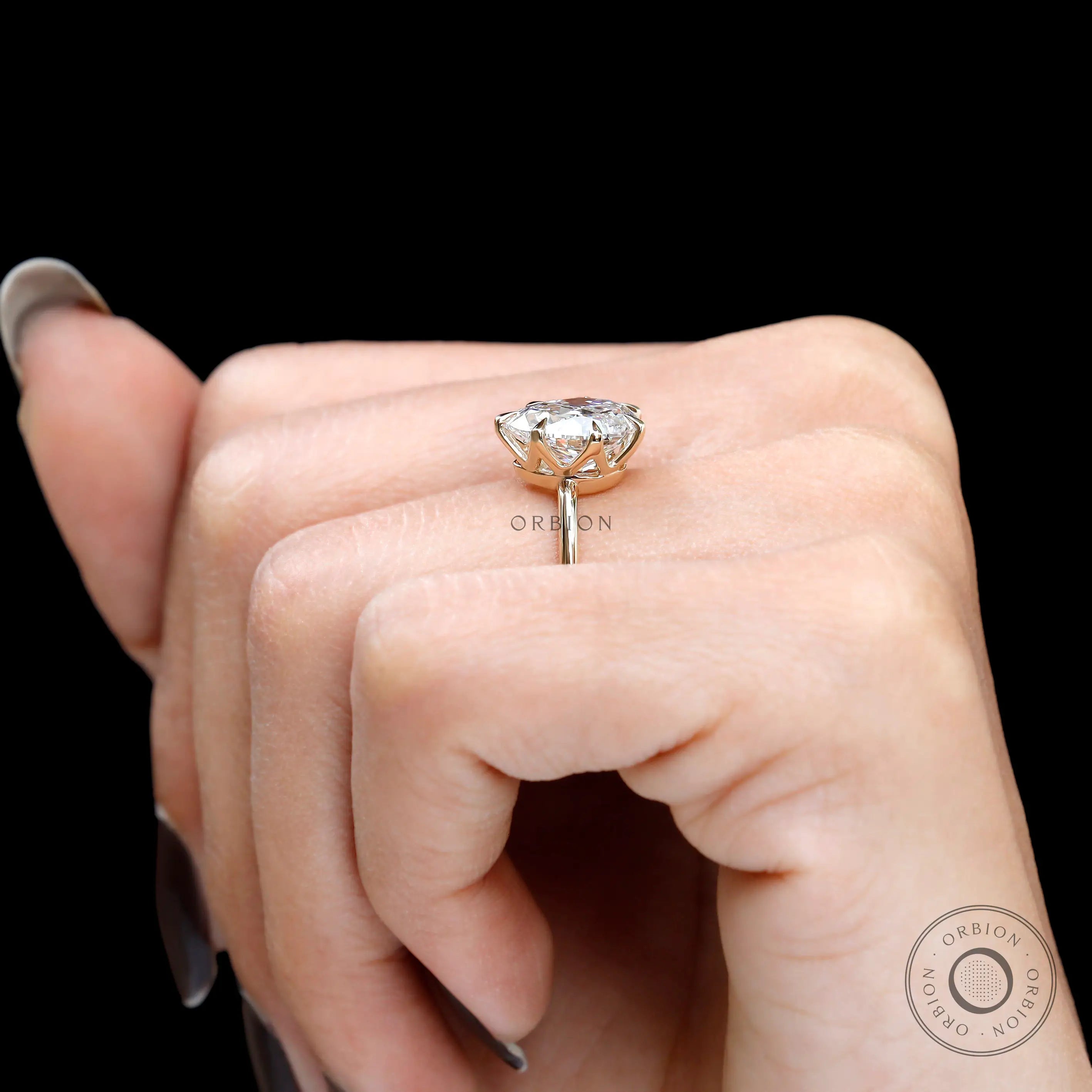 Low profile crown setting displayed on hand against black background