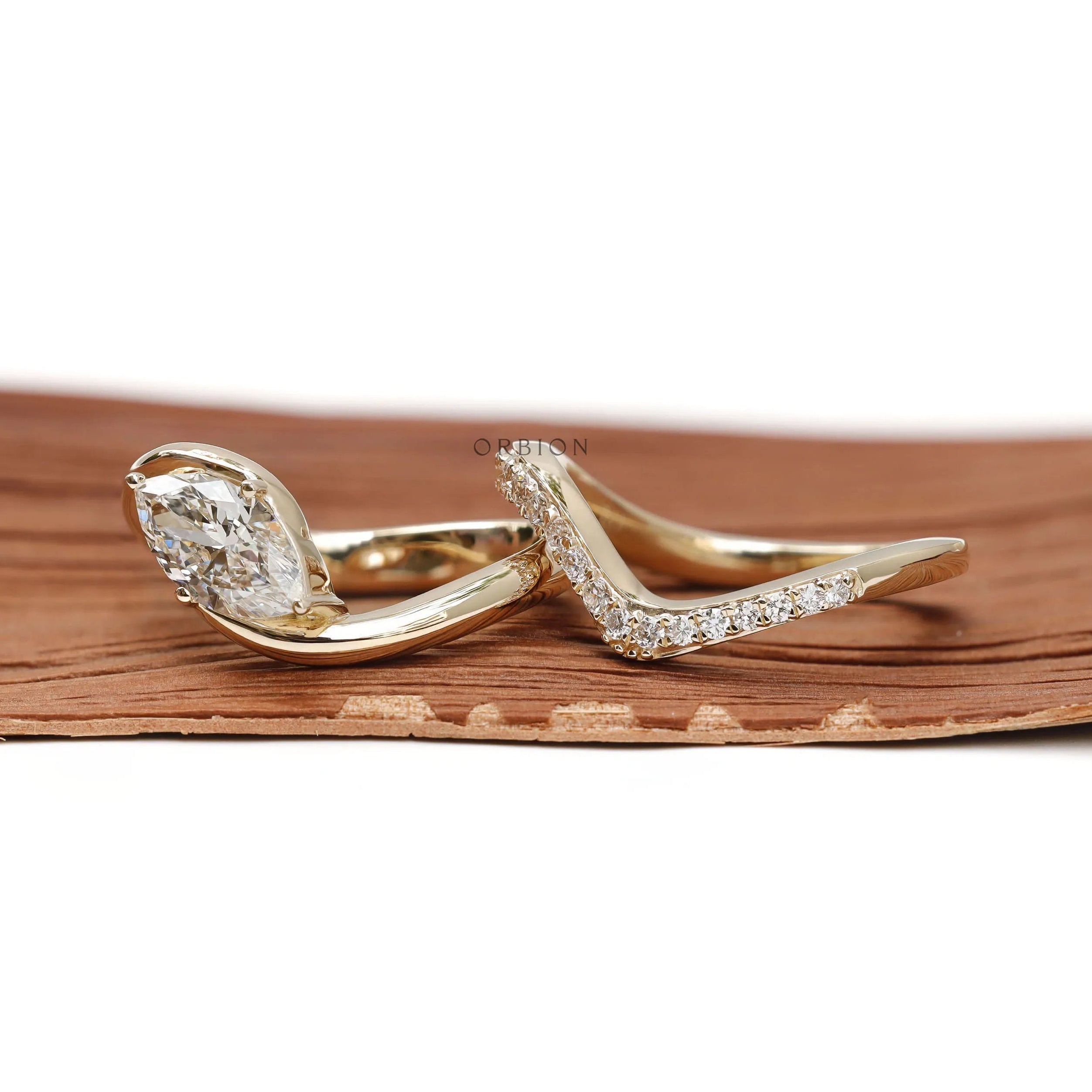 Moissanite marquise wave engagement ring set in 14K yellow gold