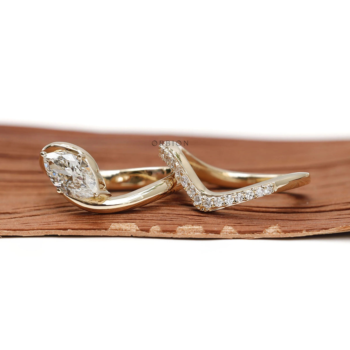 Moissanite marquise wave engagement ring set in 14K yellow gold