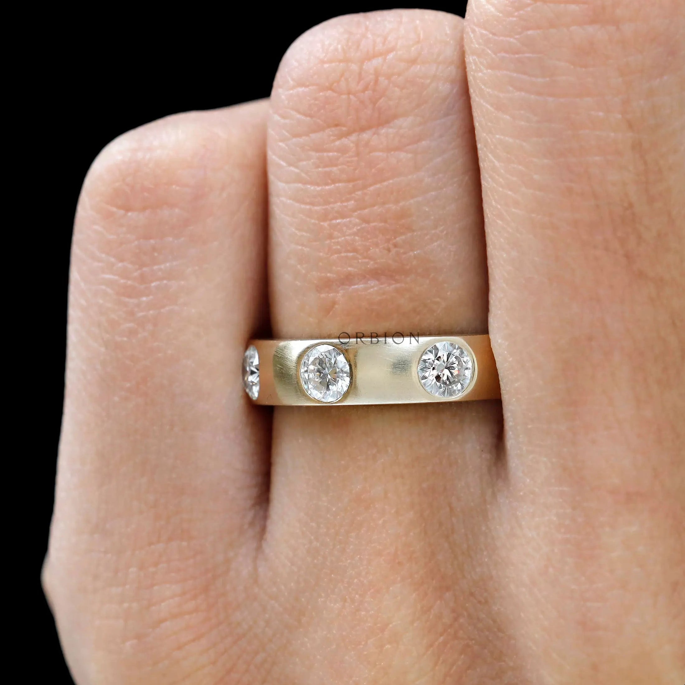 Round brilliant flush set eternity ring  on finger