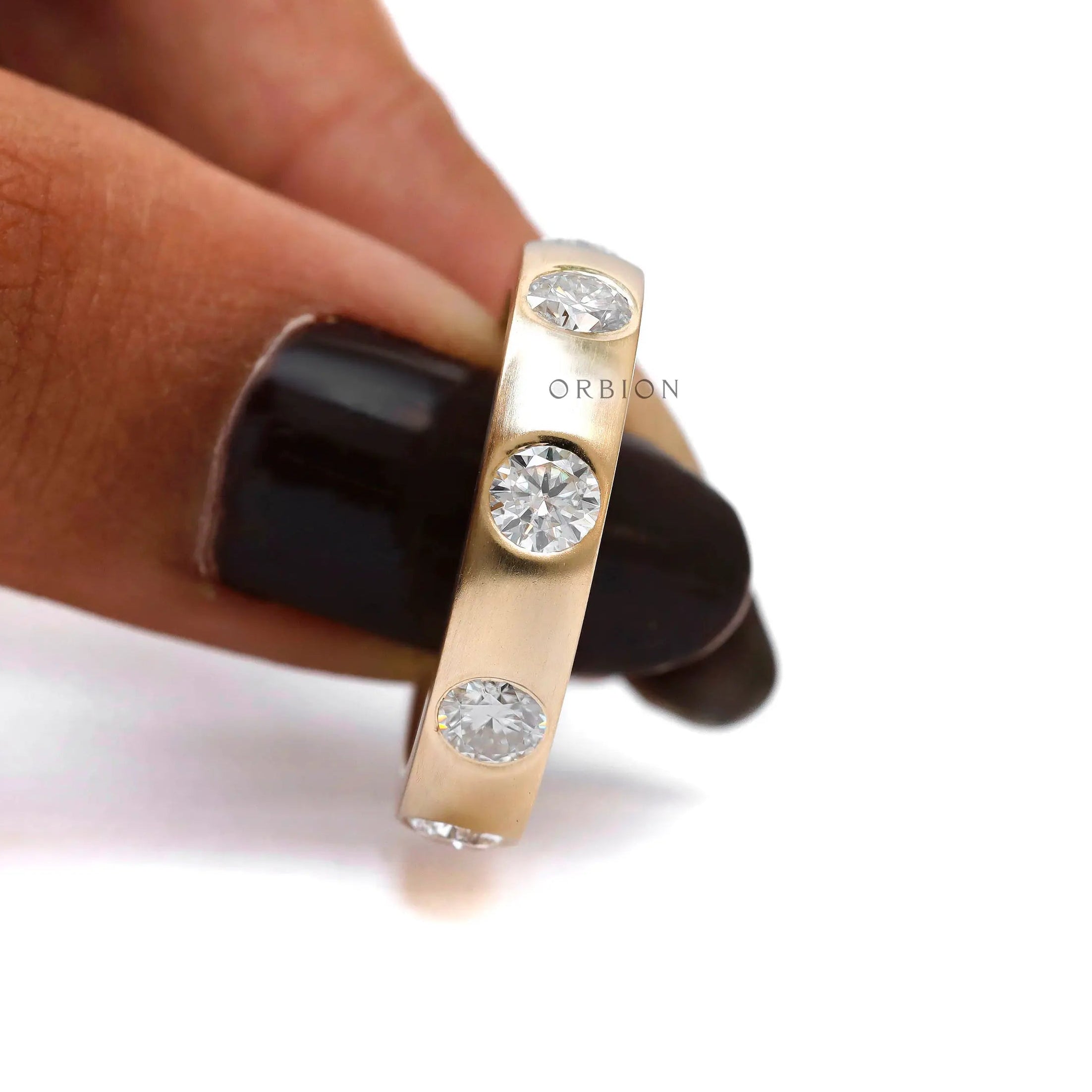 Station style flush set moissanite eternity ring close up