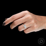 Contemporary two stone pear engagement ring on finger