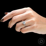 Round 2 CT solitaire cathedral engagement ring in 18K white gold on hand