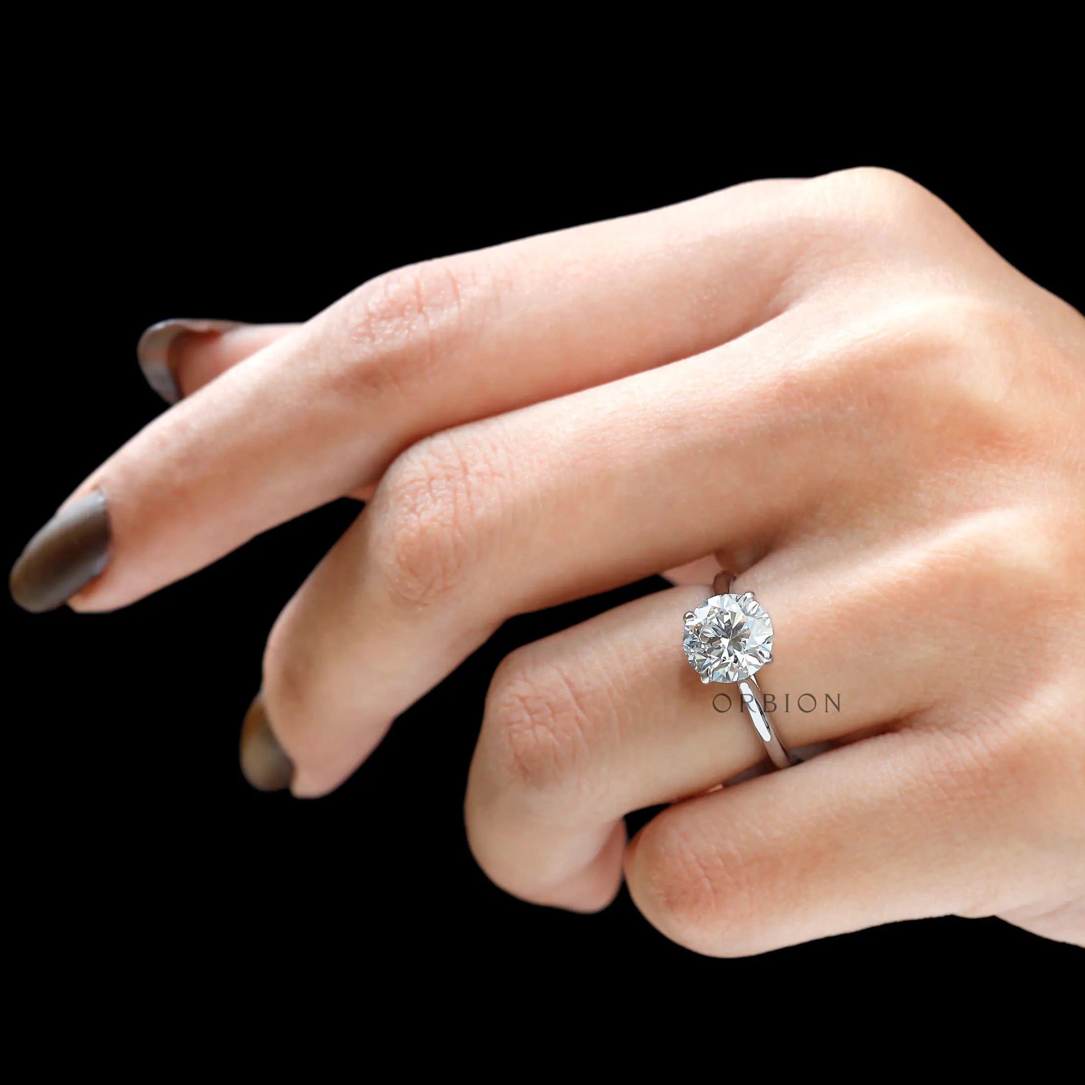 Round 2 CT solitaire cathedral engagement ring in 18K white gold on hand