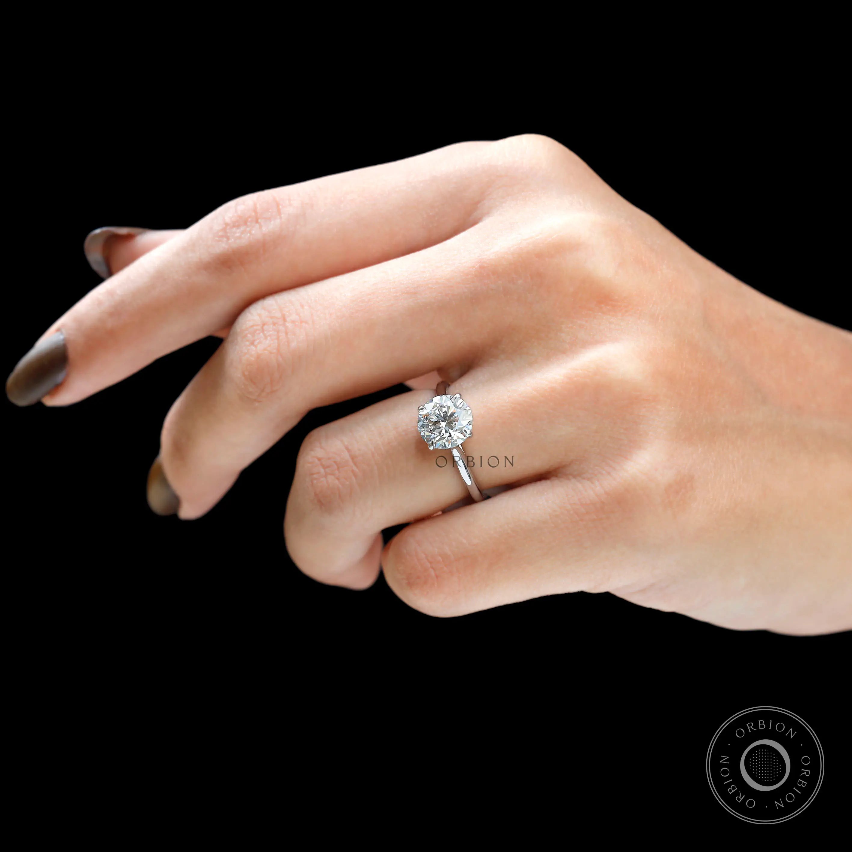 Round 2 CT solitaire cathedral engagement ring in 18K white gold on hand