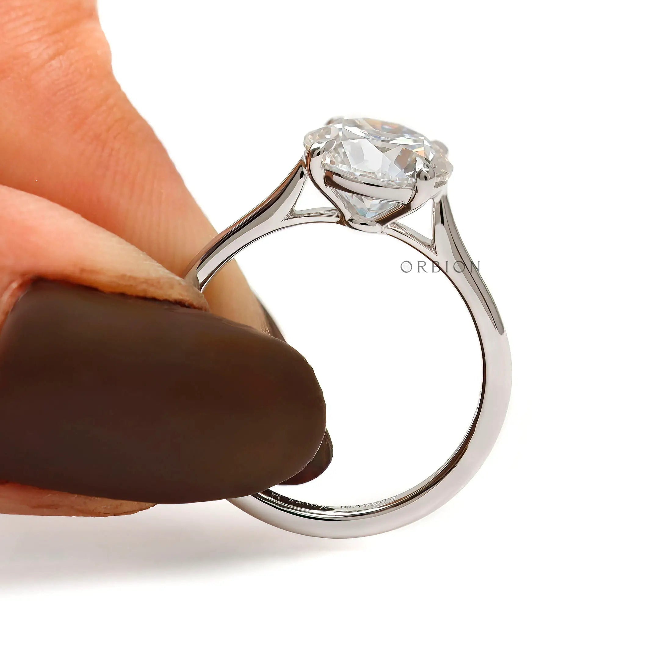 Cathedral setting round moissanite engagement ring side view
