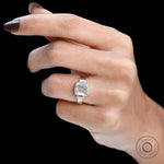 Solitaire emerald cut bezel set three stone moissanite ring yellow gold