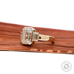 Emerald cut three stone thick band engagement ring yellow gold