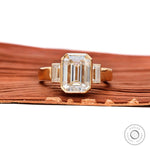 Emerald cut three stone bezel ring front view