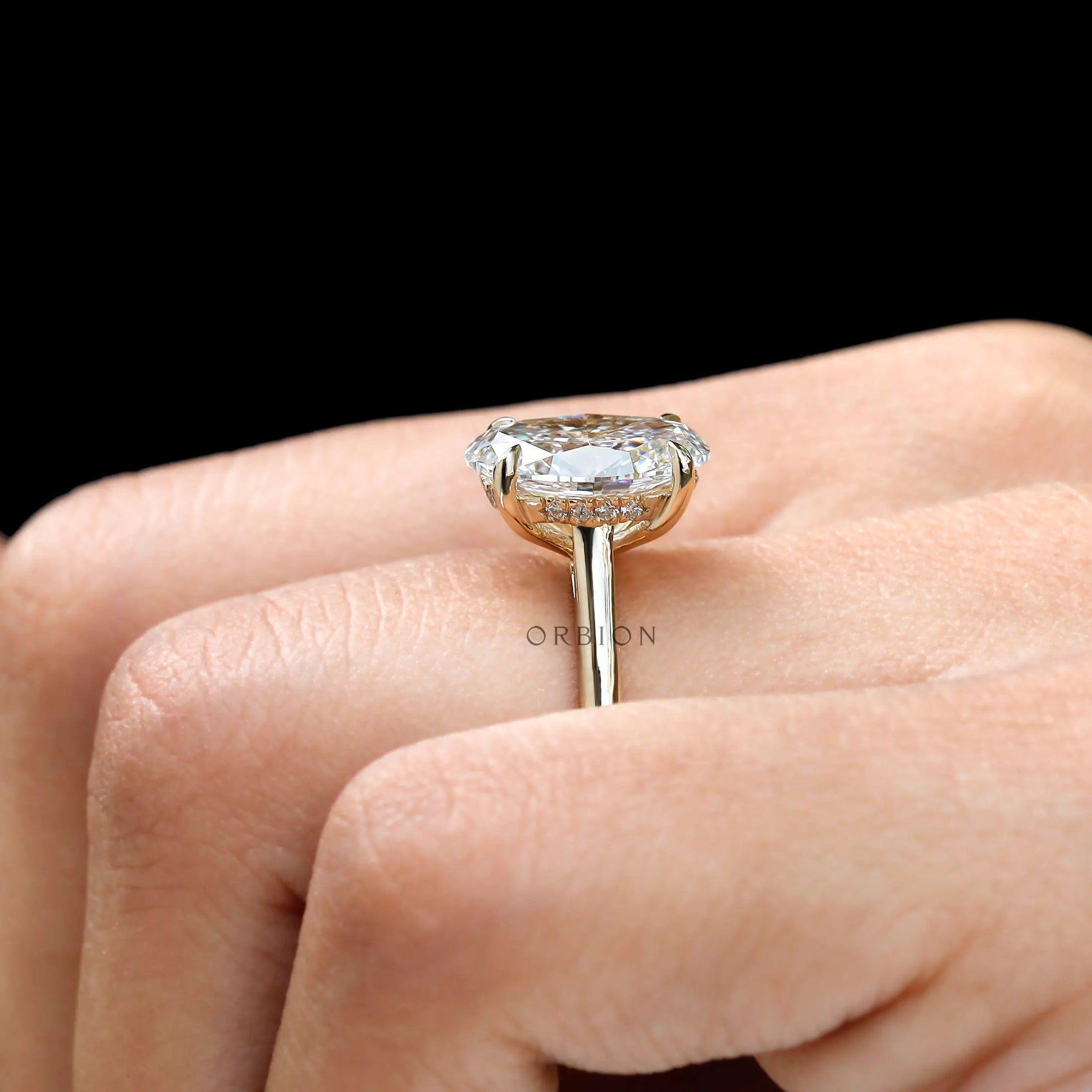 Side view of hidden halo solitaire oval cut promise ring