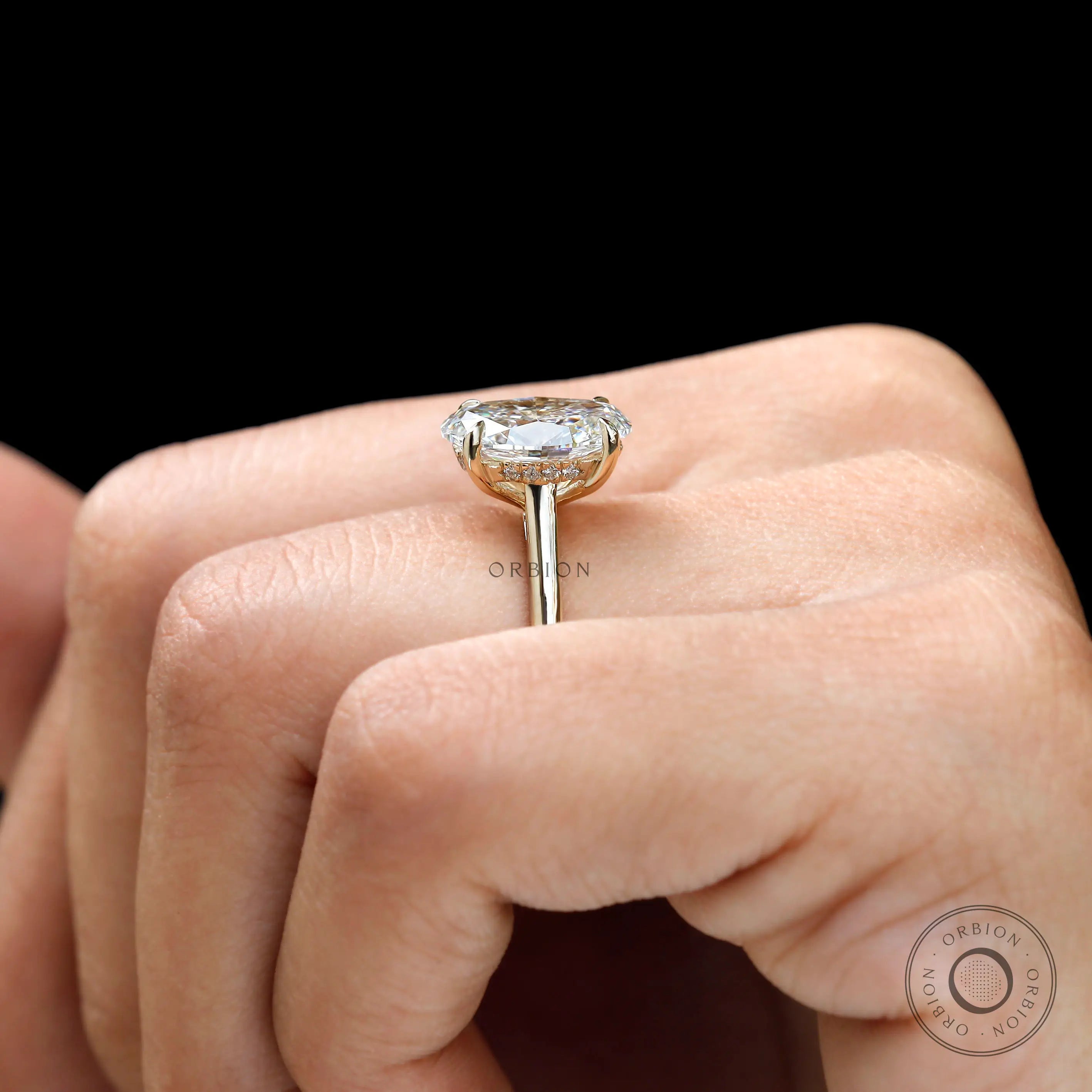 Side view of hidden halo solitaire oval cut promise ring