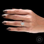 Cathedral setting oval diamond ring on finger