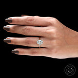 Cathedral setting oval diamond ring on finger