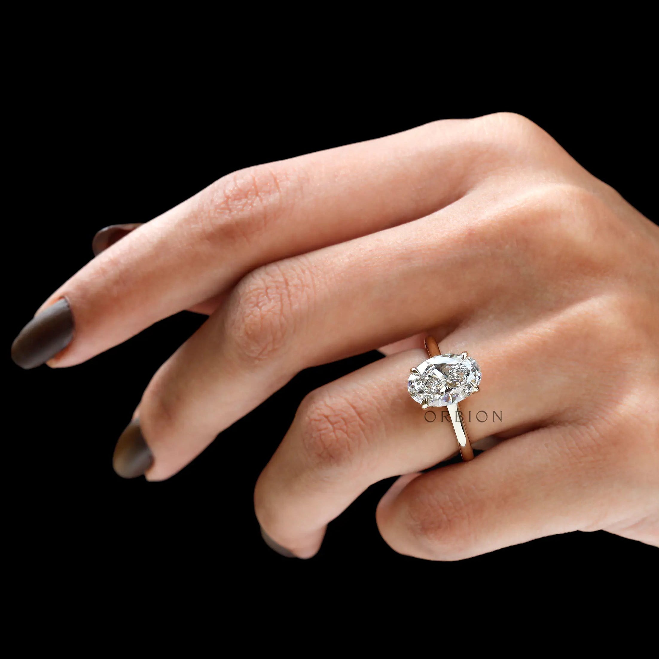 Elegant 3 carat solitaire oval ring worn on hand lifestyle view