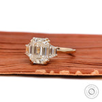 Three stone moissanite ring with step cut trapezoid accents