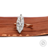 Side view of cathedral marquise engagement ring with hidden halo