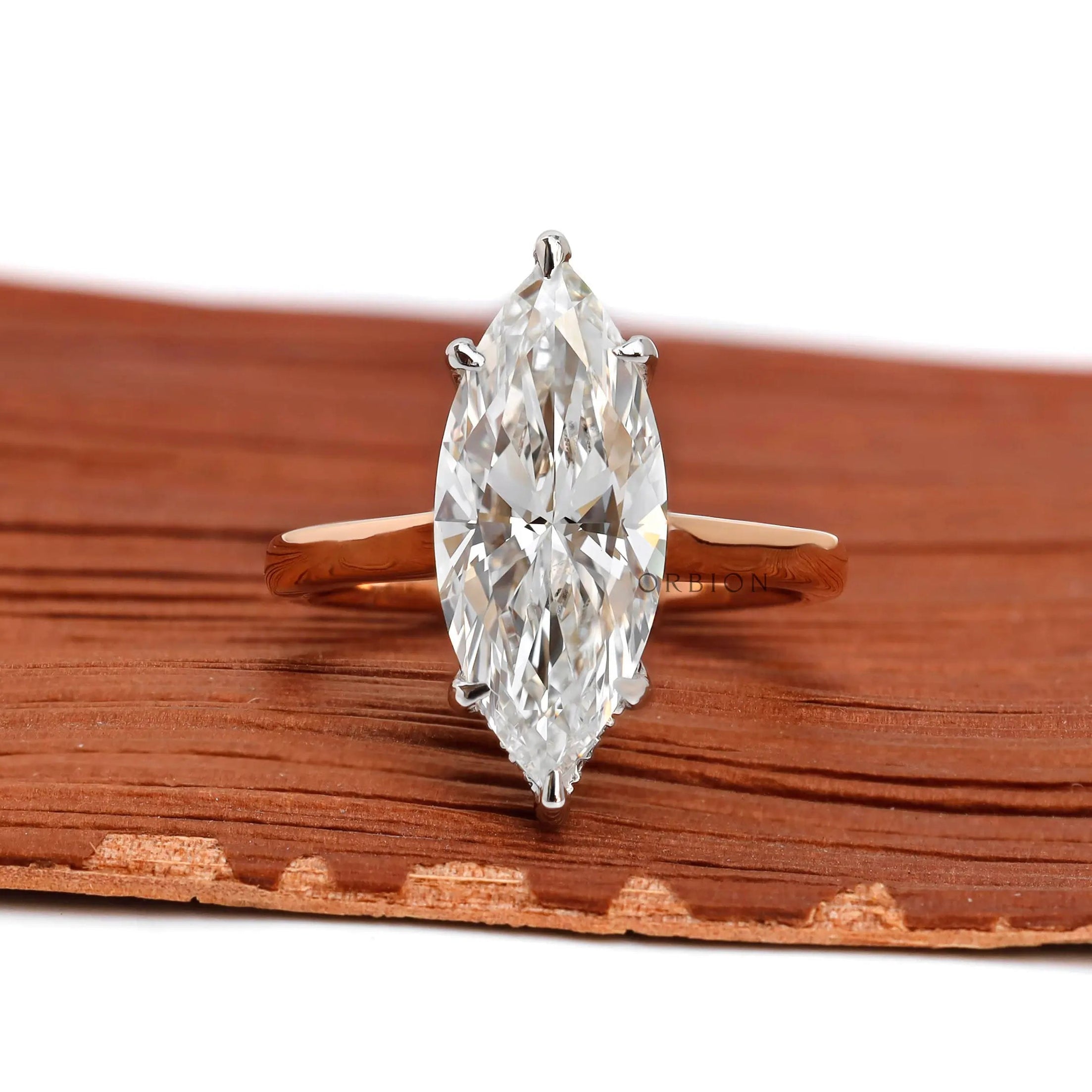 Marquise cut lab diamond hidden halo engagement ring in two tone gold