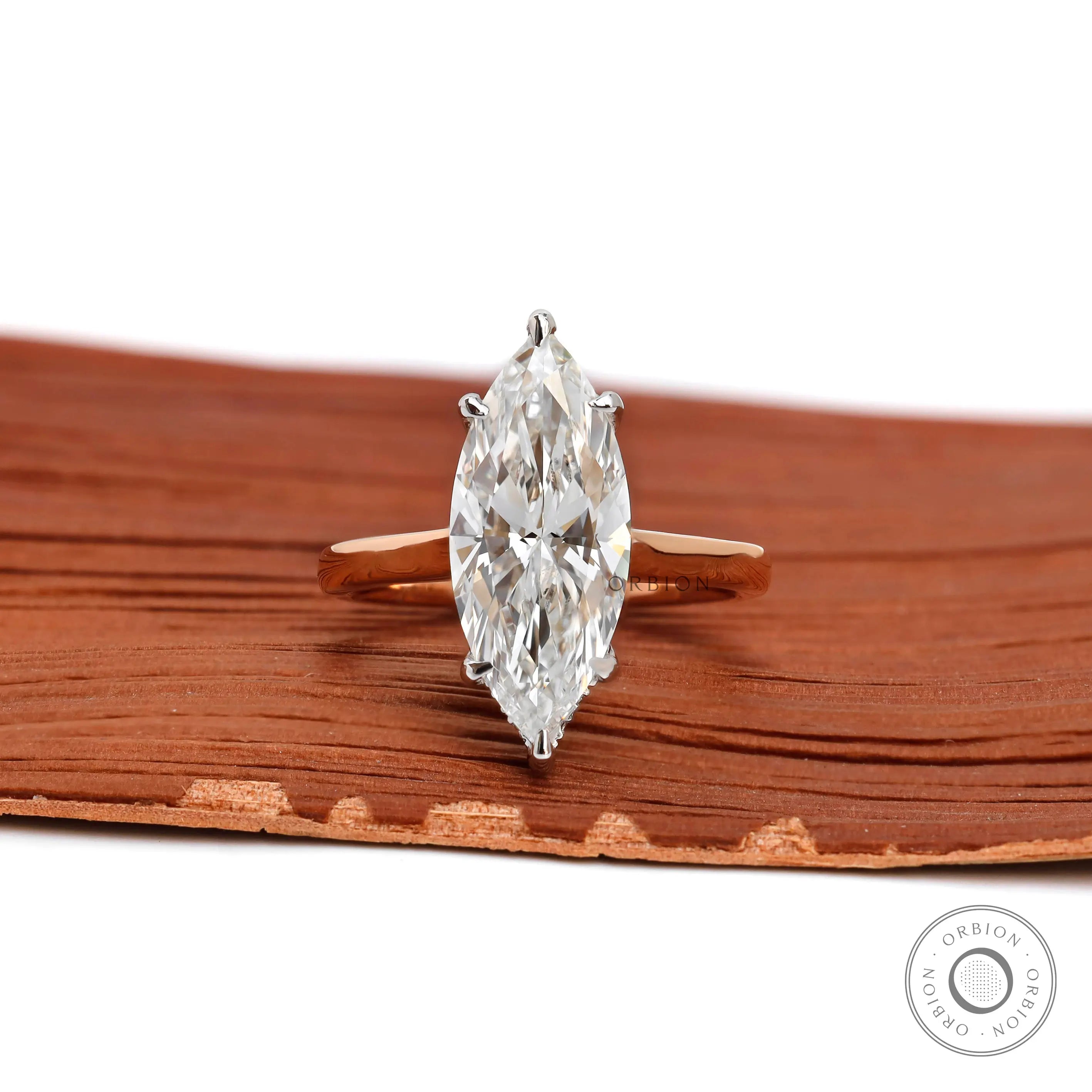Marquise cut lab diamond hidden halo engagement ring in two tone gold