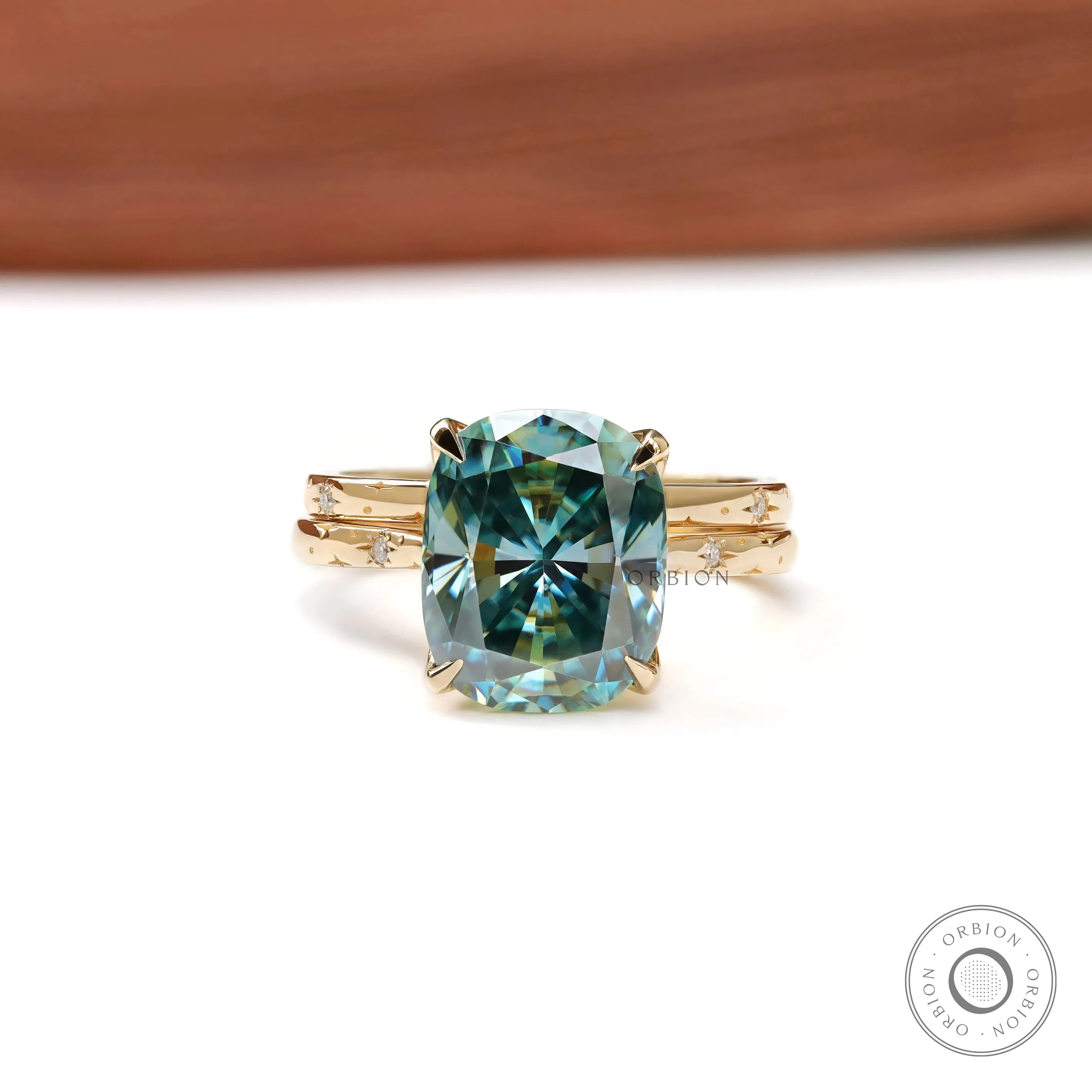 Elongated cushion blue green moissanite starburst ring with celestial band in 18k yellow gold